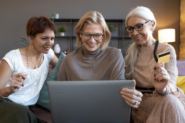 Friends using laptop for online shopping