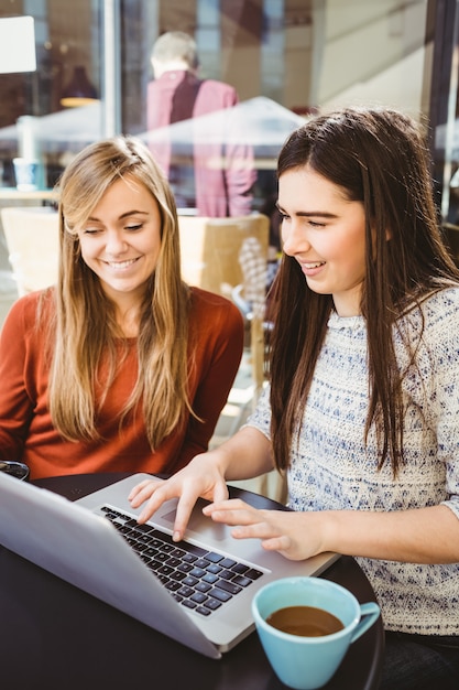 Friends using laptop together