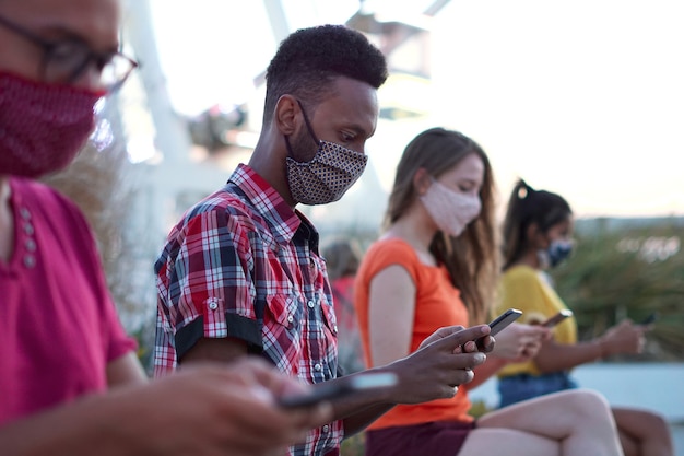 Friends using smartphone outdoors