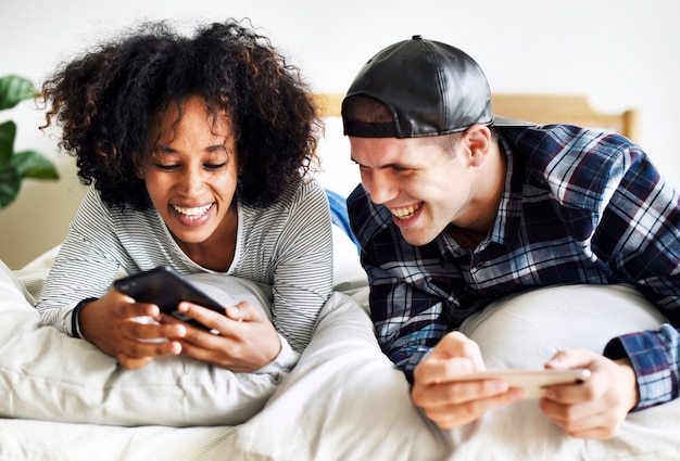 Friends using smartphone together at home