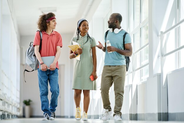 Friends walking along corridor after lessons