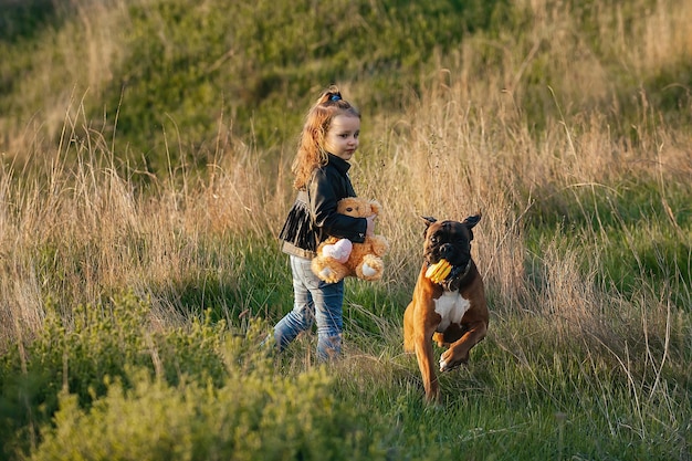 friendship between children and dogs, a little girl on a walk with a four-legged friend