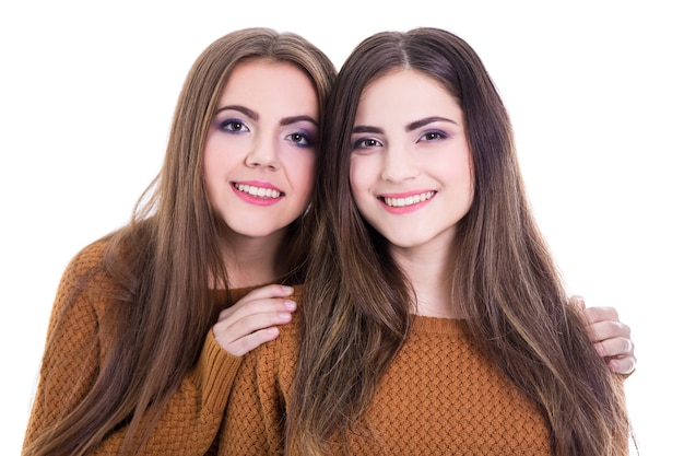 Friendship concept - portrait of two girls isolated on white background