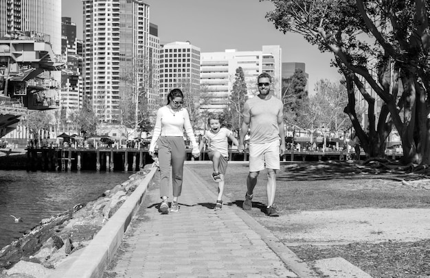 Friendship father mother and child spend time in park friendly family having fun in summer