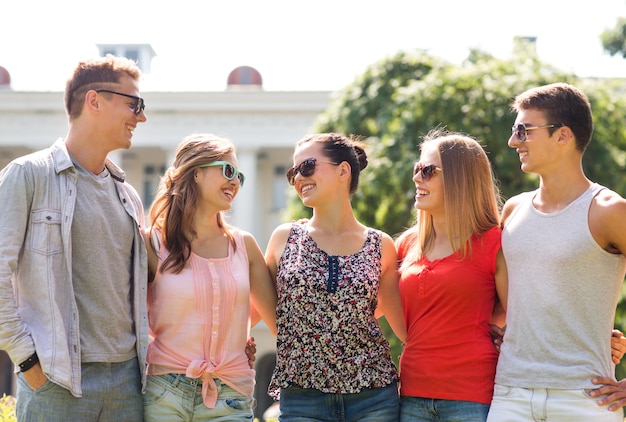 friendship, leisure, summer and people concept - group of smiling friends outdoors