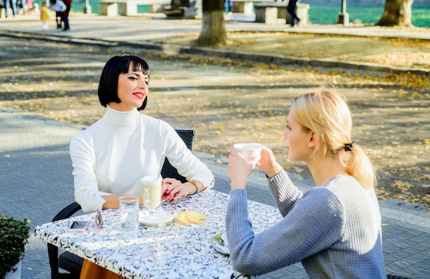 Friendship meeting Female friendship Trustful communication Girls friends drink coffee and talk Conversation of two women cafe terrace True friendship friendly close relations Sharing thoughts