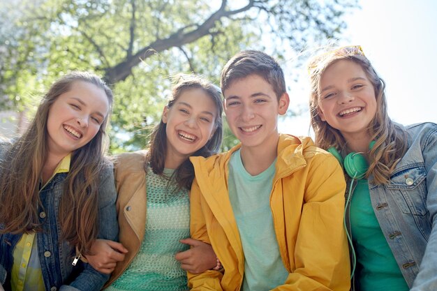 friendship and people concept - group of happy teenage students or friends outdoors