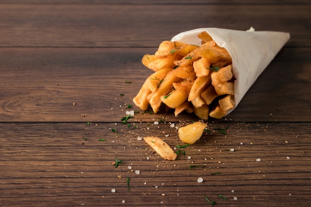 Frieten, in een papieren zak op hout