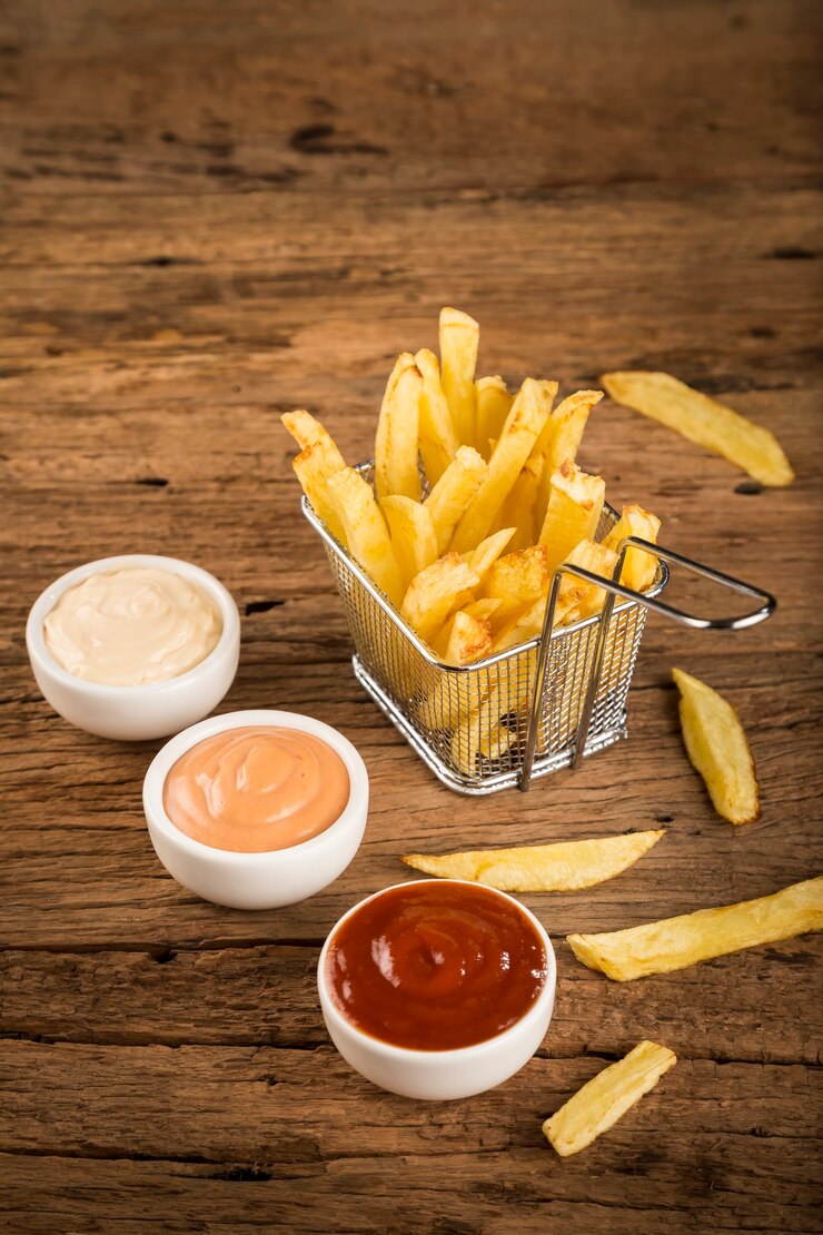 Frieten met sauzen op rustieke houten achtergrond