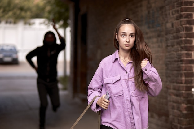 Frightened female is running alone at day time on street.\
action. woman afraid of rapist