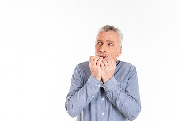 Frightened man looking up at copy space and afraid isolated