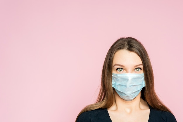 Frightened woman in a protective mask.