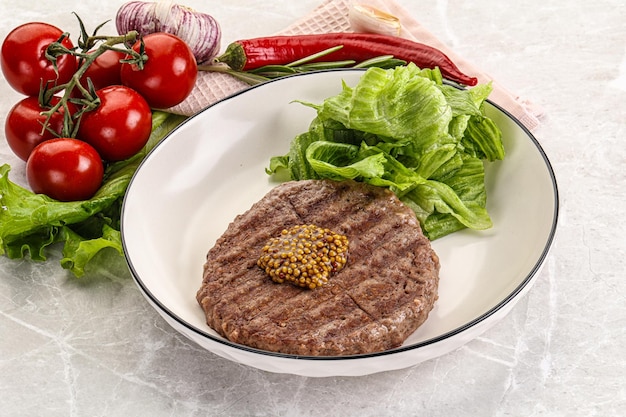 Frilled beef burger cutlet with iceberg salad