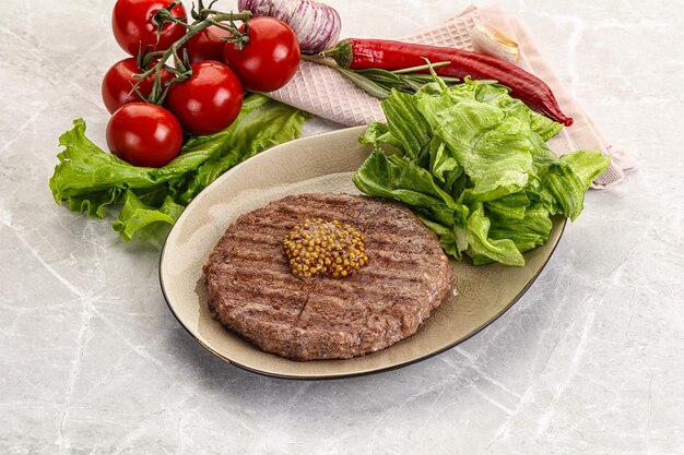 Frilled beef burger cutlet with iceberg salad