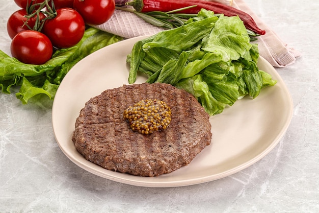 Frilled beef burger cutlet with iceberg