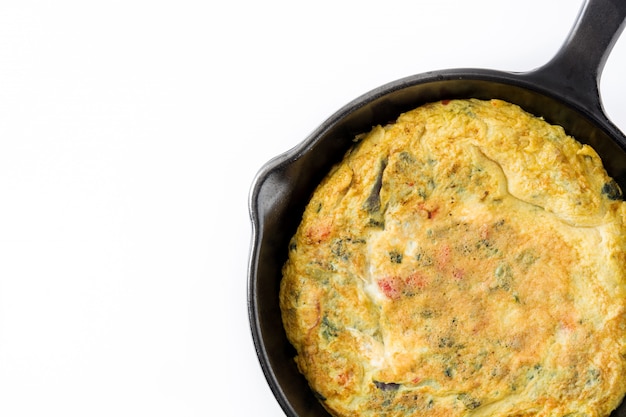 Frittata made of eggs and vegetables in a iron pan