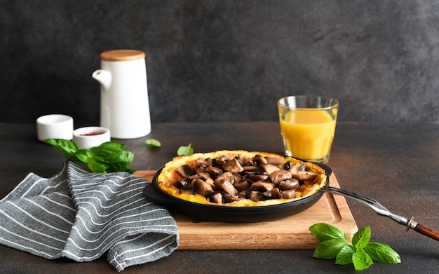 Frittata with mushrooms for breakfast with orange juice