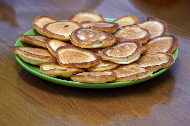 Fritters on a plate on a wooden table