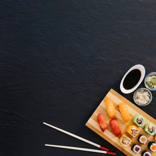 Photo from above chopsticks and condiments near sushi