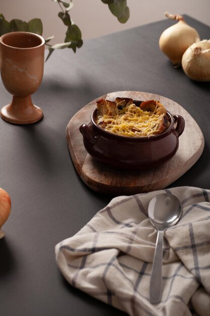 Photo from above dutch still life with  french onion soup in chiaroscuro light