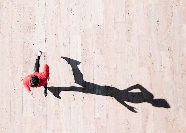 Photo from above sportsman sprinting on pavement