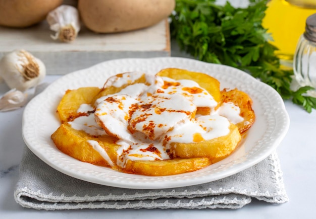 From Turkish cuisine french fries potatoes with yoghurt sauce Turkish name Yogurtlu patates