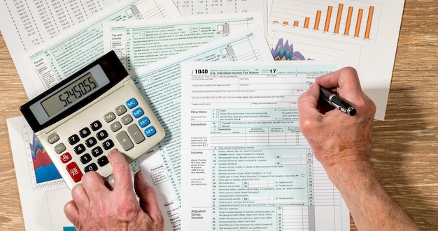 From above view of 2017 IRS form 1040 on wooden desk