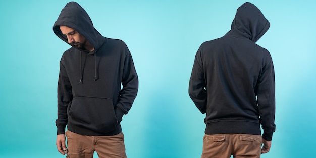 Photo front and back view of a black hoodie mockup for design print on blue background