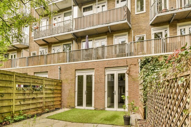 The front of a brick apartment building with a yard