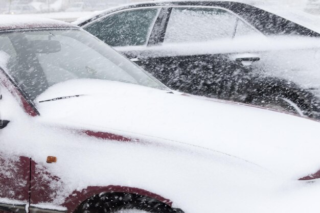 The front of the car the bonnet under a layer of snow