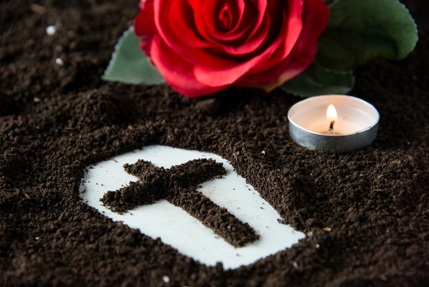 Photo front close view of coffin shape with candle and red flower death grim reaper funeral