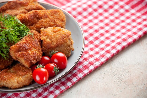 Front close view tasty chicken wings with greens and tomatoes on light background sandwich meat fries burger dinner meal food lunch