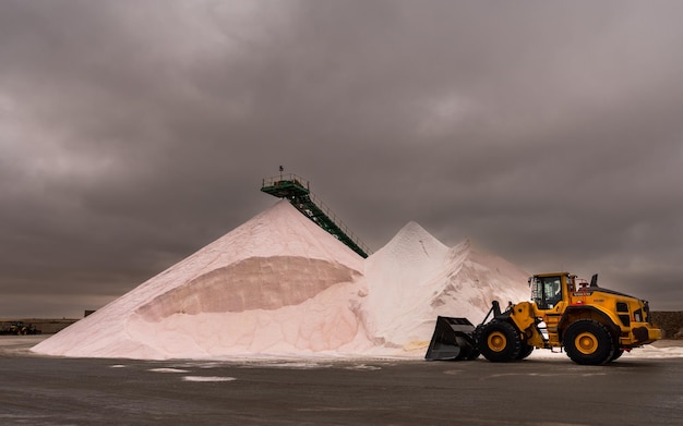 Front end loader loading from a large heap of course salt