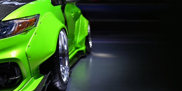 Front headlights of green modify car,copy space