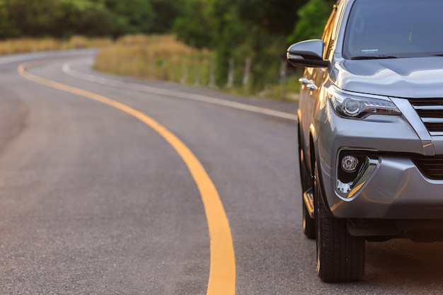 Front of new silver SUV car parking on the asphalt road