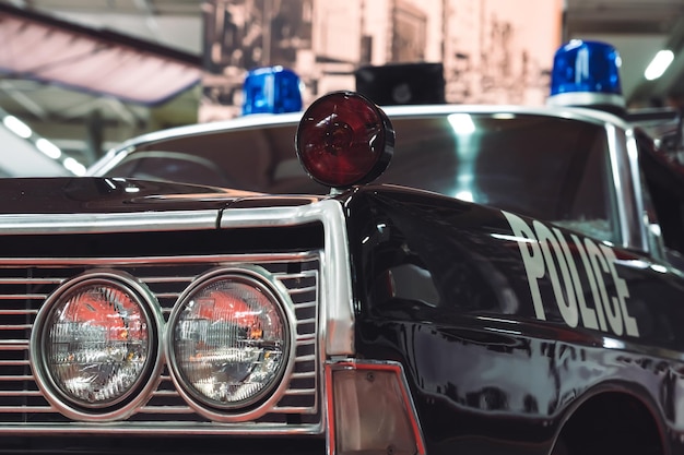 Photo in front of an old american police car