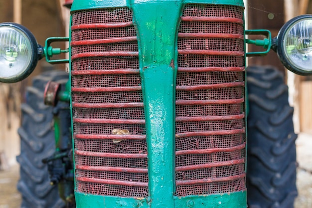 Photo front of an old small tractor for farmers.