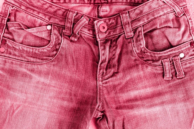 Front part jeans pants red pink purple color concept of female and women's health and problems of the pelvic floor and genitals denim background toned in viva magenta trend color of the year 2023