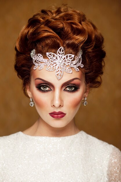 Front portrait of a bride, having high fashion bridal make up and hairstyle, with bridal accessories