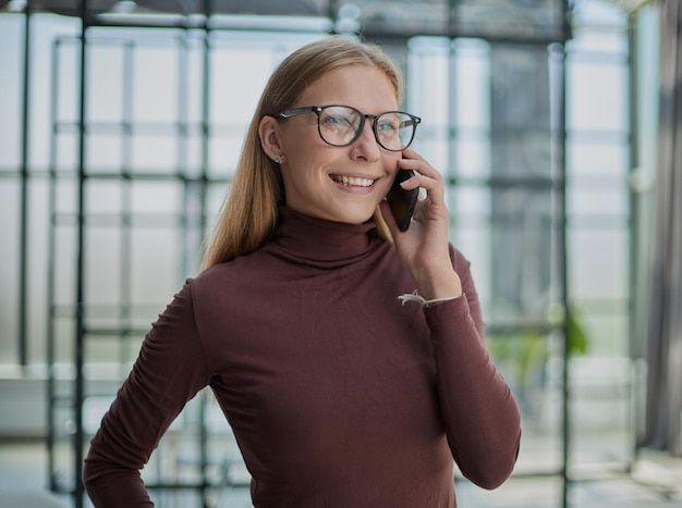 Front portrait of pretty young woman in office