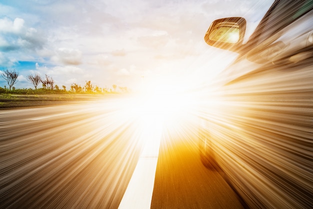 Front side view of black car driving fast.