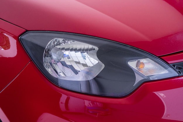Front side view Headlight of modern red car