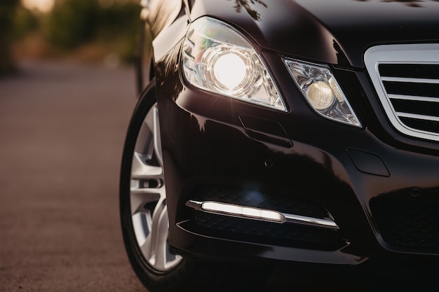 Front of a sports car. Close up detail on one of the headlights.