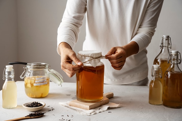 Photo front view adult with kombucha jar