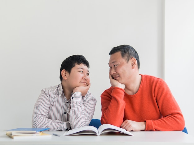 Front view asian father and son looking at each other