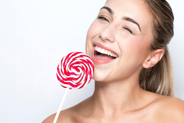 Front view of beautiful woman with lollipop