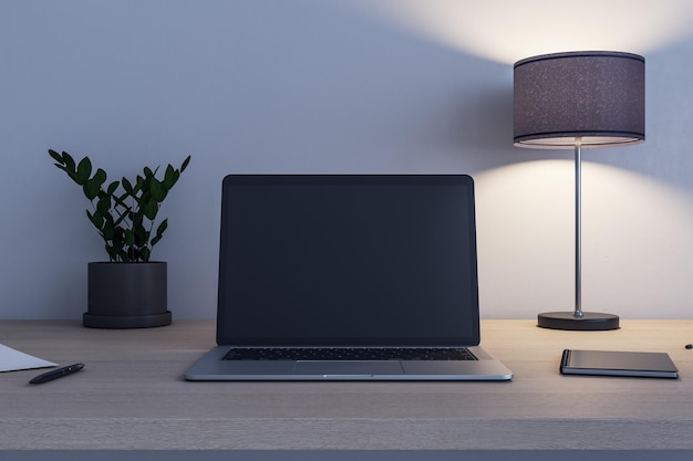 Front view on blank black modern laptop screen with place for your logo or text on wooden table with flowerpot switched on lamp and notebook 3D rendering mock up