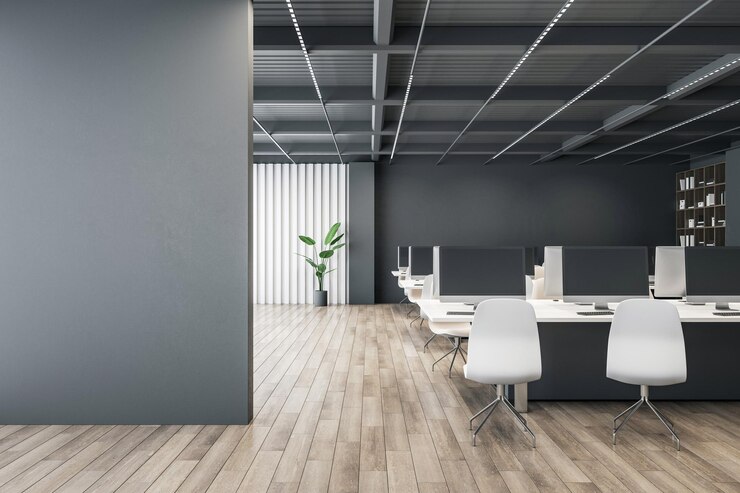 Photo front view on blank dark grey wall with place for advertising poster or text in spacious coworking office with white work furniture on wooden floor on dark wall background 3d rendering mockup