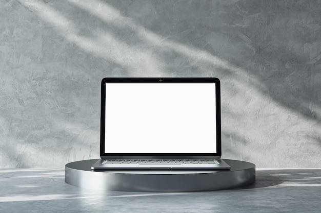 Front view on blank white modern laptop screen with place for your logo or text on dark metallic round stand on abstract sunlit light grey concrete background 3D rendering mock up