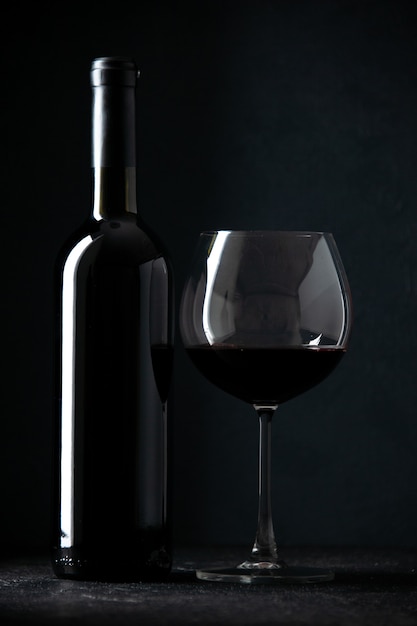 front view bottle of wine with empty glass on dark background alcohol restaurant darkness color champagne photo